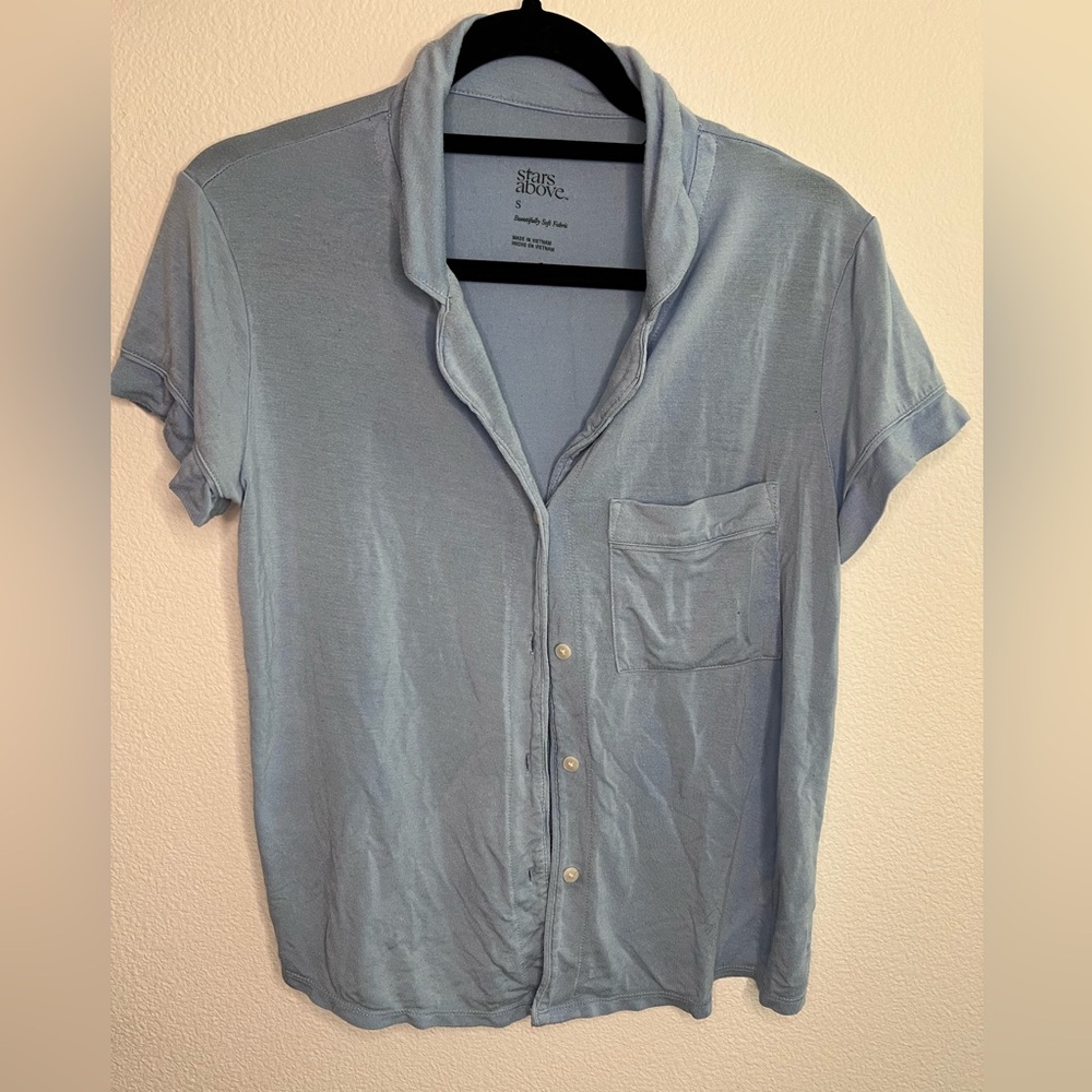 Baby blue stars above sleep PJ shirt. Light blue short sleeve button up shirt.